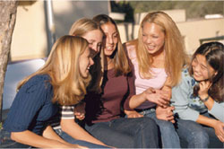 An image of adolescent girls chatting in a park